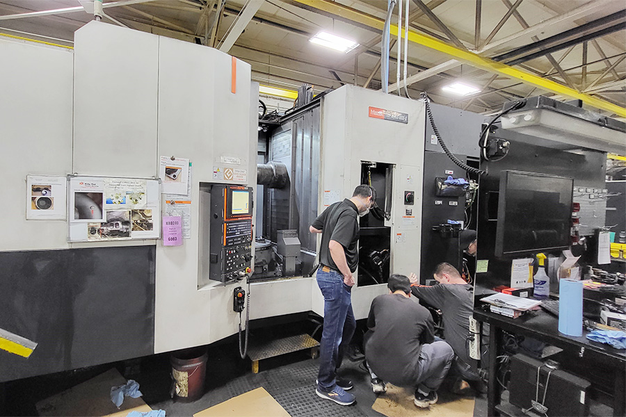 A group of students working at Kirby Risk Precision Machining in Lafayette, IN